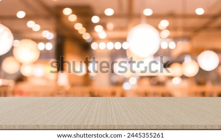 abstract blur modern interior restaurant night club bar counter with wood tabletop vintage style for show and design ads or content on display concept