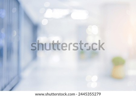 abstract blur modern interior inside entrance building of office in blue background with orange light effect for ads design and banner template presentation concept