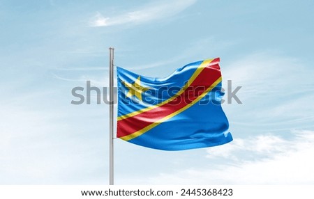 DR Congo national flag waving in the sky.