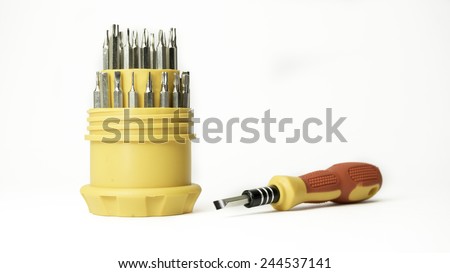 Interchangeable screwdriver set with different types of metal steel heads and bits. Isolated on white background.