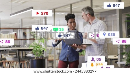 Image of multiple notification bars over diverse coworkers discussing reports on laptop. Digital composite, multiple exposure, business, planning, teamwork, social media reminder and technology.