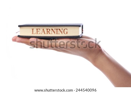 Hand with small book written Learning isolated on white background.