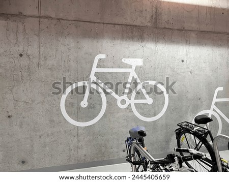 Bicycle hall, bicycle racks in concrete hall, painted bicycle signs, healthy lifestyle and public transport, bicycle parking ride storage, Sustainable living, Environmental awareness, Bike-sharing
