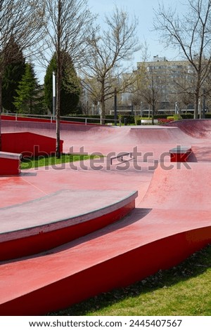 Skate Extreme sports ground. 
Empty public red skate park. Skateboard in city.