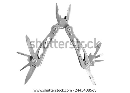 Multitool. Folding multifunctional tool. Knife, pliers, taps, scabbard. Tourist tool. On an empty background. Royalty-Free Stock Photo #2445408563