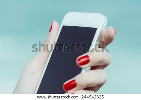 Retro Photo Of Young Girl Hand Holding Mobile Phone Similar To iPhone