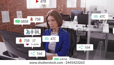 Image of multiple notification bars over asian woman working on computer in office. Digital composite, multiple exposure, business, social media reminder and technology concept.