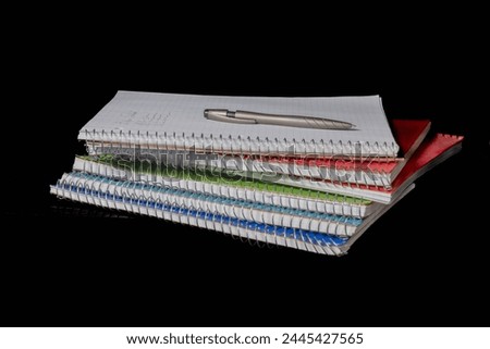notebooks and notes against black background ready for school