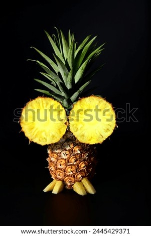 "Summer fun" Creative design of funny face with the big eyes and weird hair style that made from pine apple.