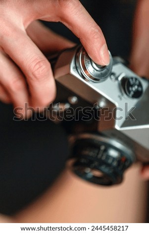 A close-up view of a persons hands holding a camera, ready to take a picture.