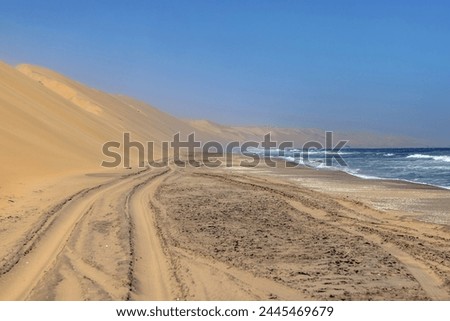 Picture of the beach of the dunes of Sandwich Harbor in namibia tgas over in summer at low tide