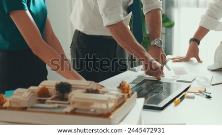 Close up of smart business team hand working together to plan design while looking at project plan from tablet and discussing about blueprint and building construction at meeting table. Alimentation. Royalty-Free Stock Photo #2445472931