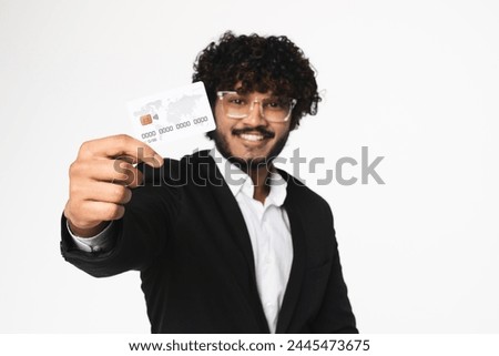 Focused photo of credit debit card and Indian businessman holding it isolated over white background. Loan salary wages contactless payment, e-banking, e-commerce