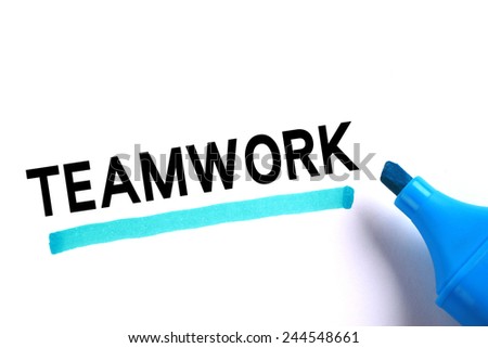 Teamwork word with blue marker on white background.