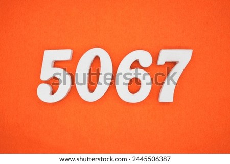 Orange felt is the background. The numbers 5067 are made from white painted wood.