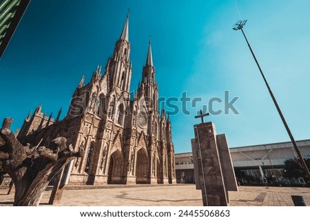 Exteriors during the afternoon of the Cathedral "Diocesan Sanctuary of Our Lady of Guadalupe" of Zamora Michoacan, shows Gothic style architecture. Royalty-Free Stock Photo #2445506863