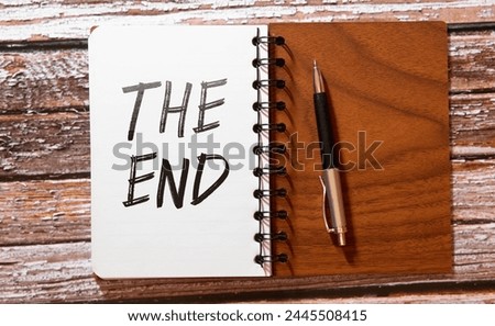 The End sign with clouds and sky background.