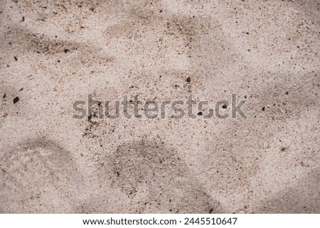 This is a close up picture of sand, providing an interesting texture of nature.