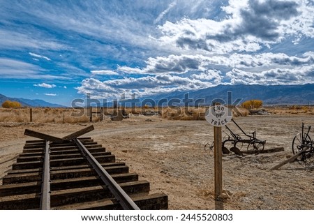 A sign marks the end of these railroad tracks