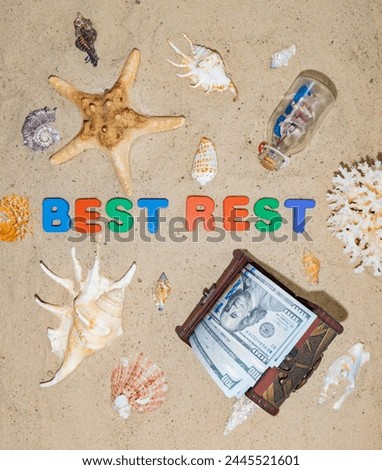 Money for travel, journey, vacation, rest, holiday, dream, travel. A well-deserved vacation at an expensive seaside resort. Chest with dollars on the beach. The inscription in on the sand "Best Rest" Royalty-Free Stock Photo #2445521601