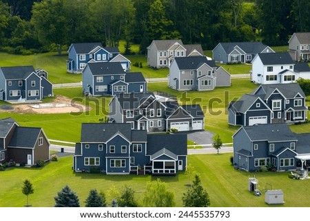 Spacious new single family homes in upstate New York residential area. Real estate development in american suburbs Royalty-Free Stock Photo #2445535793