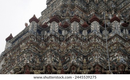 Exterior photo view of a man at the top of the Temple of Dawn or Wat Arun