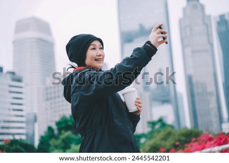 Young Woman Taking Selfie in Urban Park