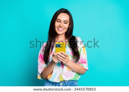 Photo of pretty young woman use smart phone empty space wear shirt isolated on teal color background