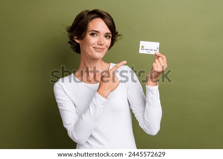 Photo portrait of lovely young lady hold point credit card dressed stylish white garment isolated on khaki color background