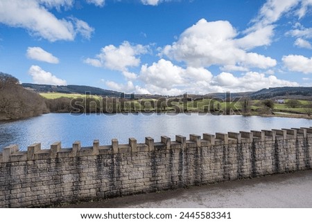 Teggs Nose Reservoir pictured over a patterned wall in Cheshire seen in the spring of 2024.