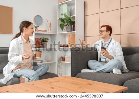 Young doctors drinking coffee in hospital lounge