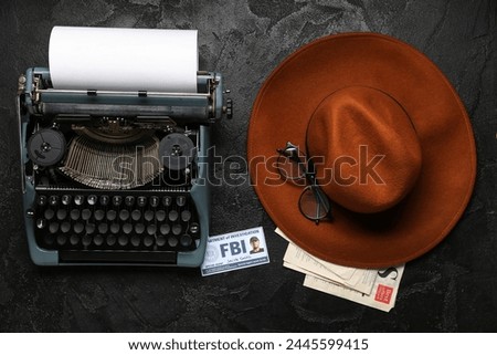 Retro typewriter, document of FBI agent, stylish hat and eyeglasses on dark background