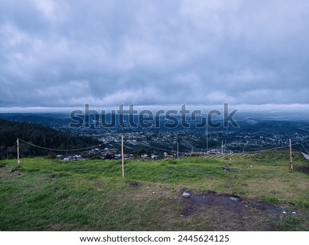 View of hills and houses with cloudy sky in Tawangmangu