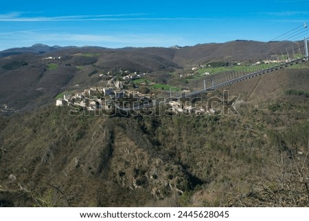 Beautiful view of a tibetan bridge in the medieval town of Sellano during sunny day of winter, Umbria region, Italy Royalty-Free Stock Photo #2445628045