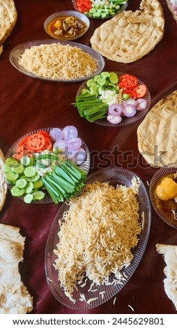 Afghani Traditional Food,
Kabuli pulao , Rice, Mutton Korma Salad, Afghani Long Bread, onion , Tomato, Cucumber, Chilly cuisine. Royalty-Free Stock Photo #2445629801
