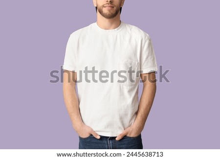 Man in stylish t-shirt on lilac background