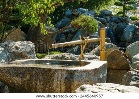 Traditional Bamboo Fountain in Japanese garden. Public landscape park of Krasnodar or Galitsky park, Russia. Cho-zu is the name of bamboo water flow in Japan