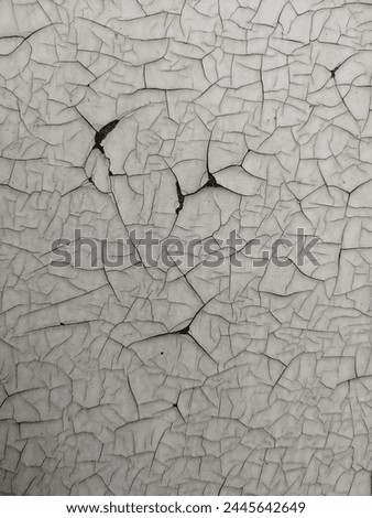 The cracked coating on very old cheap furniture, many cracks and chips form an interesting ornament.