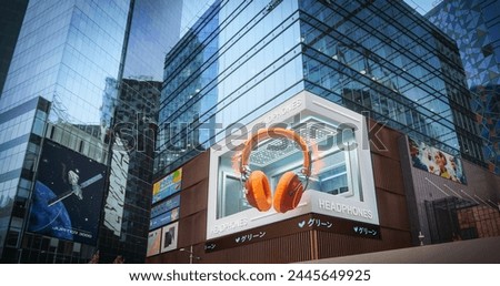 Big City 3D Billboard of a Headphones. Creative Technology Device Advert in Urban District on Skyscraper. Advertising Concept with Immersive Innovative Entertainment Display, Visual Creativity