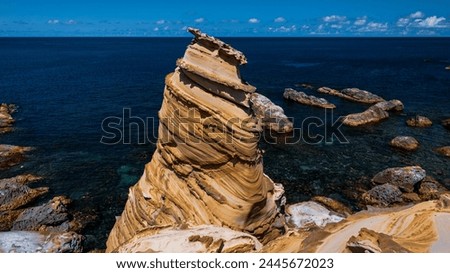 The Nanya Peculiar Rock, an isolated sandstone pillar with inclined bedding located on the coast of Ruifang District of New Taipei City, northeastern Taiwan. Royalty-Free Stock Photo #2445672023