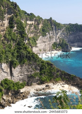 the high cliff with blue sea water in Nusa Penida, Bali-24 December 2022. Royalty-Free Stock Photo #2445681073