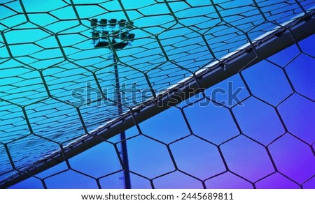 Sports background with a stadium's goalposts net, close up. Colorgraded football game backdrop, ideal for TV shows, or online betting promos Royalty-Free Stock Photo #2445689811