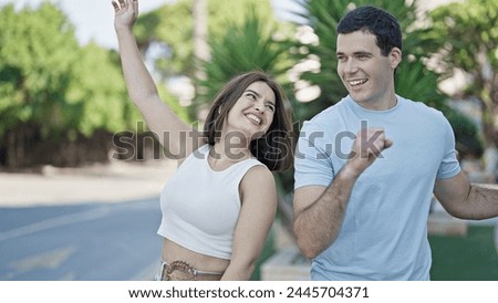 Beautiful couple smiling confident standing together dancing at park