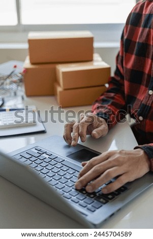 Small business entrepreneur, SME, independent male, working from home. Use smartphones and laptops for commercial inspections online marketing SME packaging box concept e-commerce team close-up photo