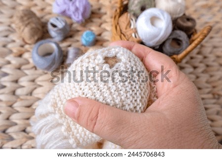wool sweater with hole on wooden mushroom for darning, materials for repairing clothes, home needlework, Sustainable DIY Fiber Projects Royalty-Free Stock Photo #2445706843