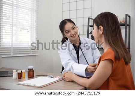Female doctor and elderly female patient who are undergoing their annual health check-up at the clinic, using a stethoscope to examine patients Royalty-Free Stock Photo #2445715179