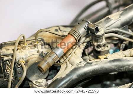 Pictures of Sparkling plug and old ignition coil with concept maintenance and repair.