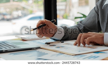 Business accounting concept Businessman uses calculator with laptop computer Budget and borrowed paper Calculate expenses, expenses, taxes online, manage company budgets, close-up images