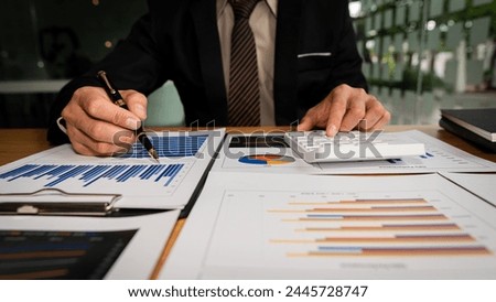 Business accounting concept Businessman uses calculator with laptop computer Budget and borrowed paper Calculate expenses, expenses, taxes online, manage company budgets, close-up images