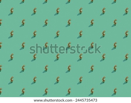 golden easter bunny on green background pattern